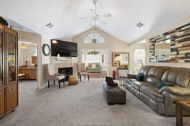 a living room with furniture a fireplace and a flat screen tv