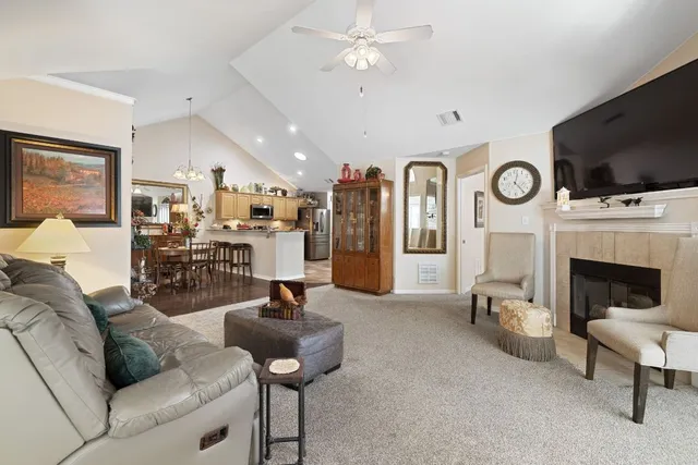 a living room with furniture a flat screen tv and a fireplace
