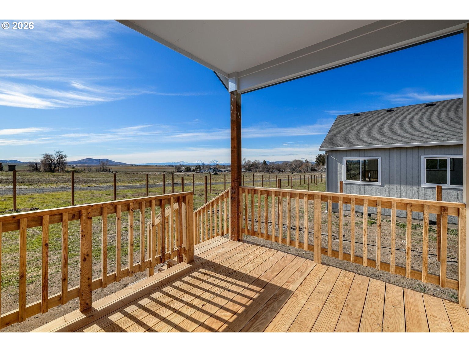518 Southwest 6th Street Madras, OR 97741 - Photo 6 of 19 a view of balcony with wooden floor and fence