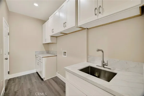 a kitchen with white cabinets and a sink