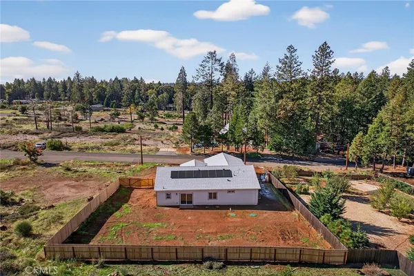a view of a swimming pool with a patio and a yard
