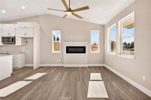 a view of empty room with wooden floor and windows