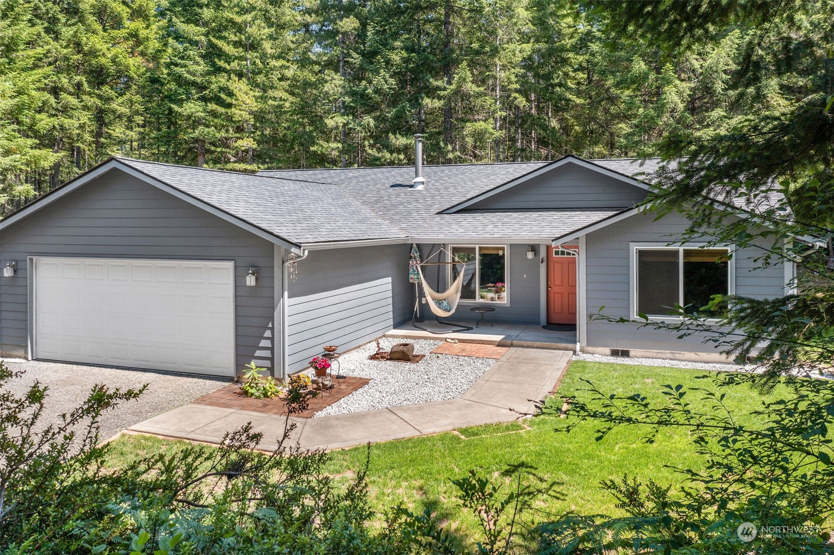 1500 Northeast Bear Ridge Road Belfair, WA 98528 - Photo 1 of 40 a front view of a house with a yard and porch
