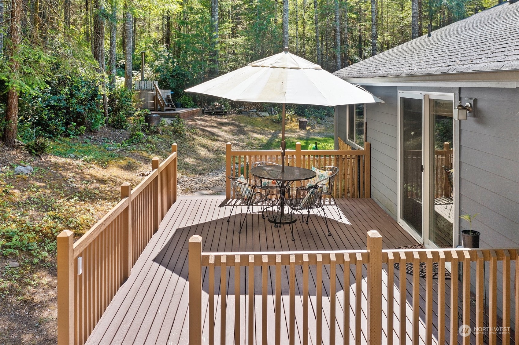 1500 Northeast Bear Ridge Road Belfair, WA 98528 - Photo 19 of 40 a view of balcony with wooden floor and outdoor seating