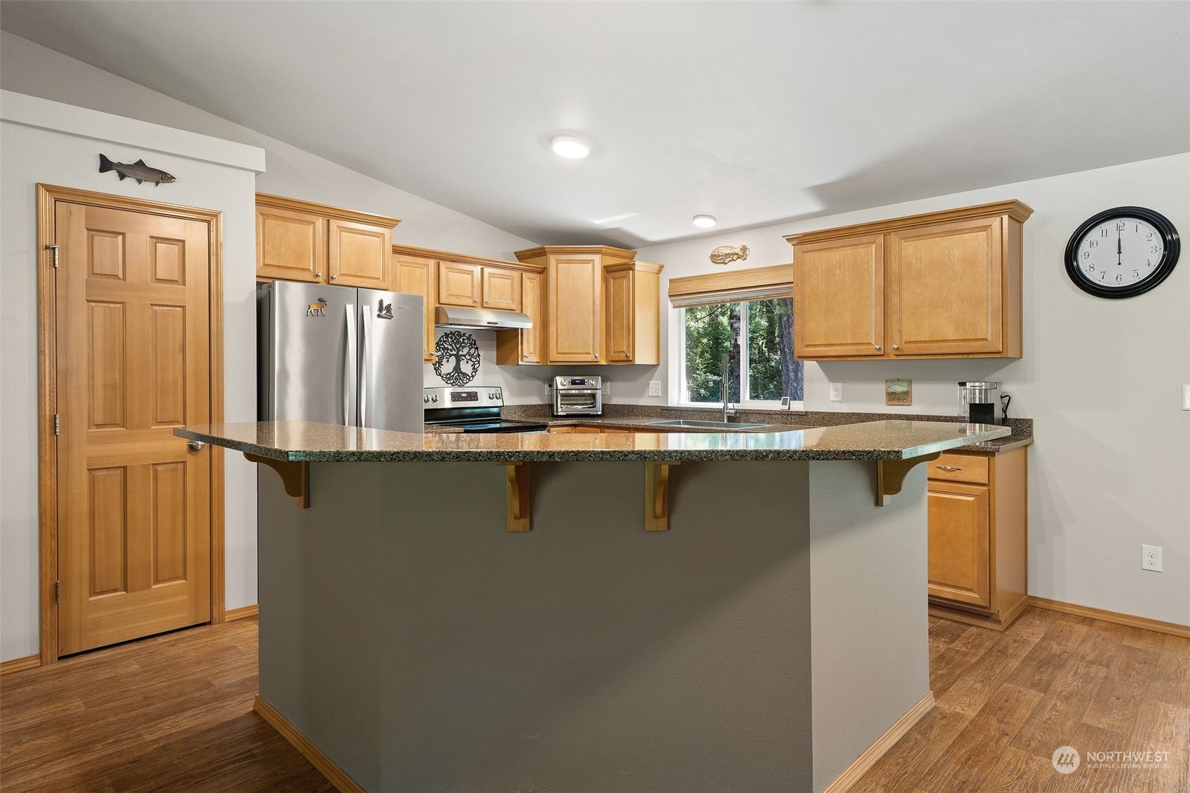 1500 Northeast Bear Ridge Road Belfair, WA 98528 - Photo 6 of 40 a kitchen with stainless steel appliances granite countertop a refrigerator a sink a stove and island