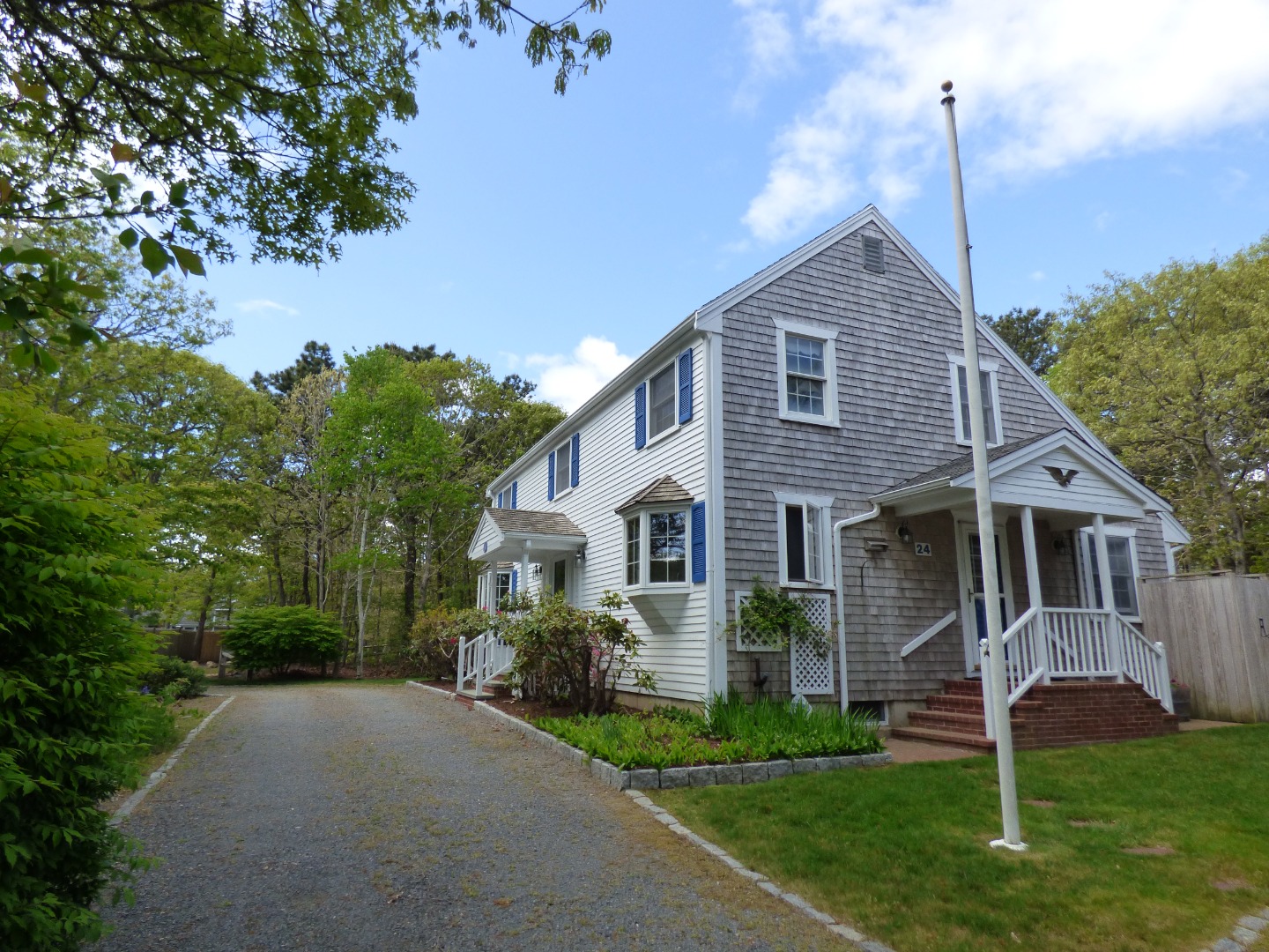 24 Mariners Way Edgartown, MA 02539 - Photo 3 of 50 a front view of a house with a yard