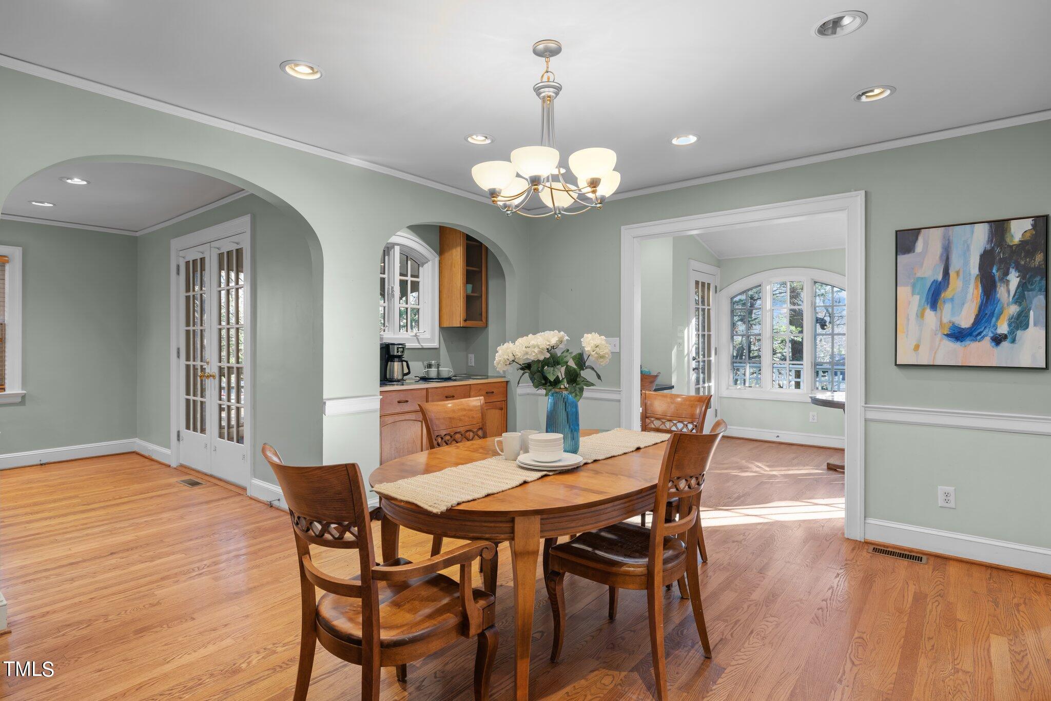228 Furches Street Raleigh, NC 27607 - Photo 18 of 65 a view of a dining room with furniture wooden floor and chandelier