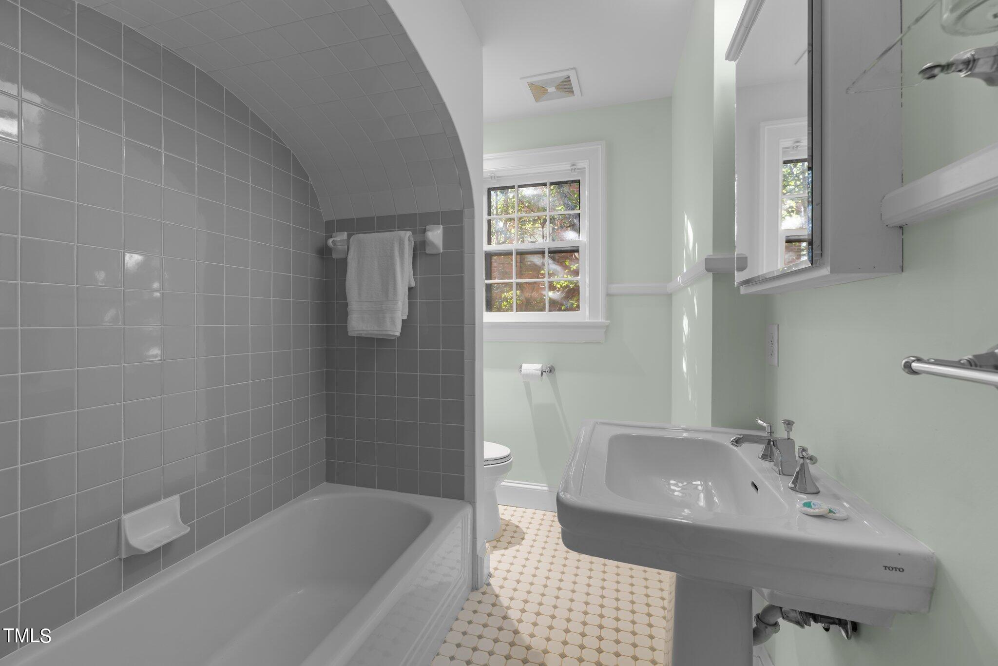 228 Furches Street Raleigh, NC 27607 - Photo 27 of 65 a bathroom with a sink a toilet and bathtub
