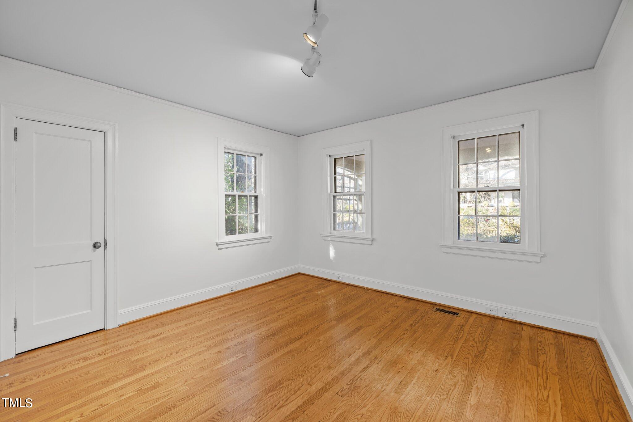 228 Furches Street Raleigh, NC 27607 - Photo 28 of 65 a view of empty room with wooden floor and fan