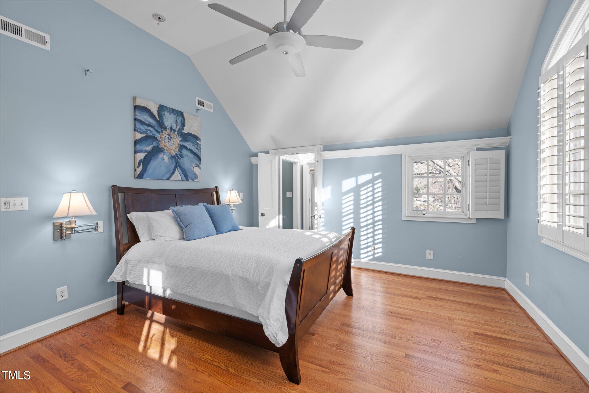 228 Furches Street Raleigh, NC 27607 - Photo 29 of 65 a bedroom with a bed and wooden floor
