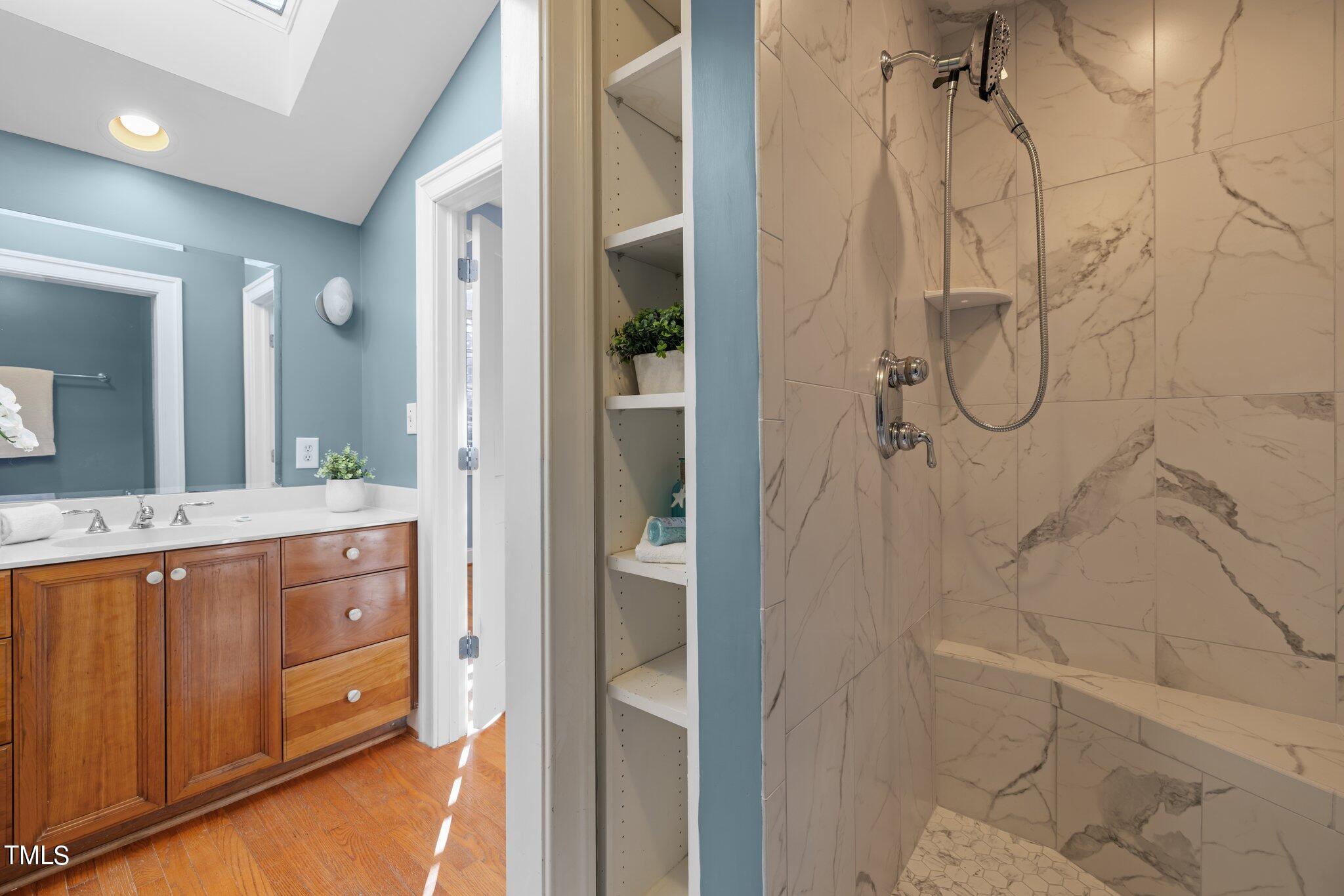 228 Furches Street Raleigh, NC 27607 - Photo 32 of 65 a bathroom with a granite countertop shower sink and mirror