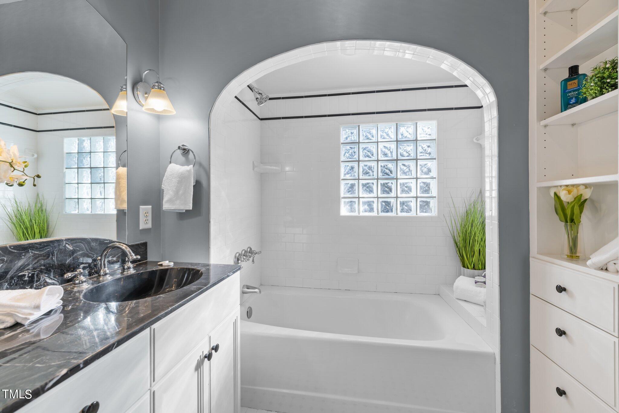 228 Furches Street Raleigh, NC 27607 - Photo 34 of 65 a bathroom with a bathtub and a sink