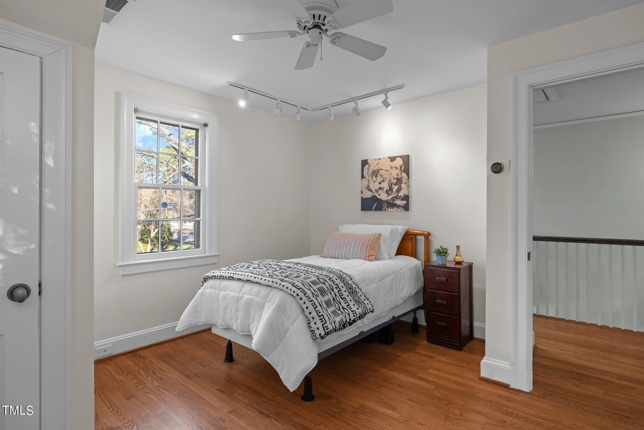 228 Furches Street Raleigh, NC 27607 - Photo 35 of 65 a bedroom with a bed and a window