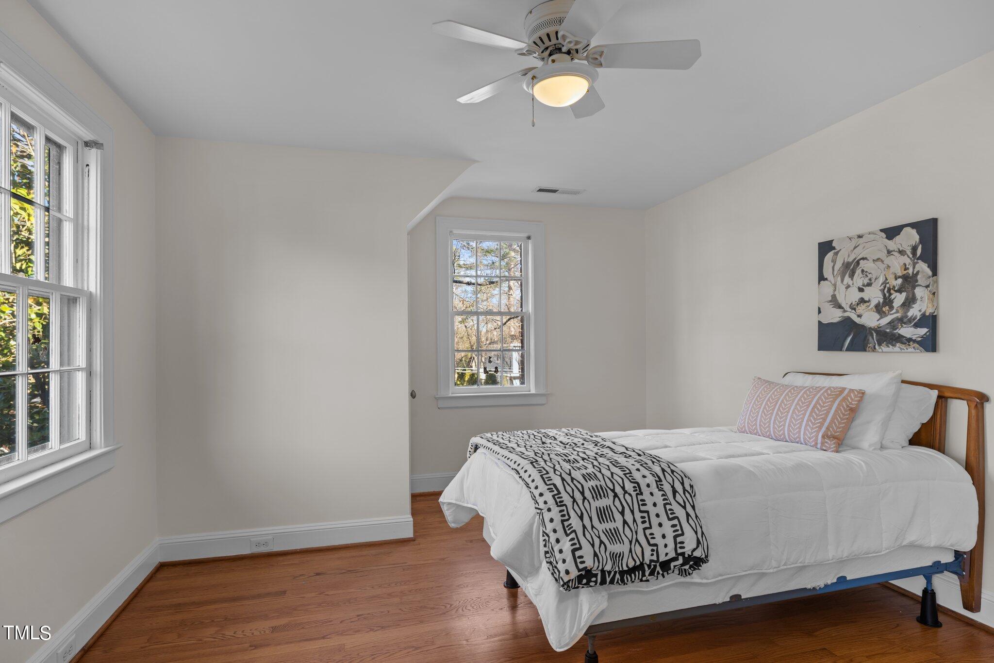 228 Furches Street Raleigh, NC 27607 - Photo 38 of 65 a bedroom with a bed and a window