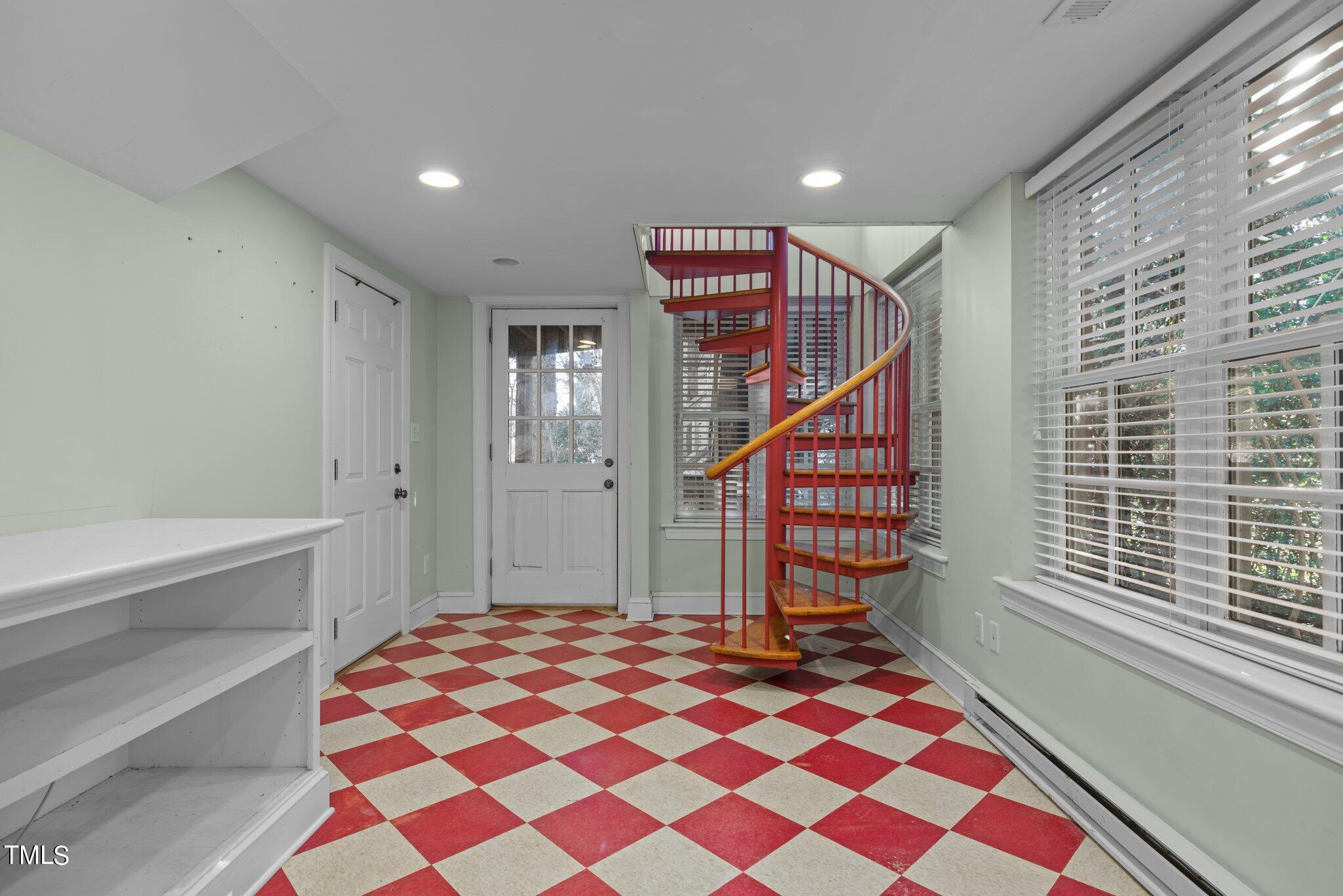 228 Furches Street Raleigh, NC 27607 - Photo 40 of 65 a bedroom with a bed and a chandelier