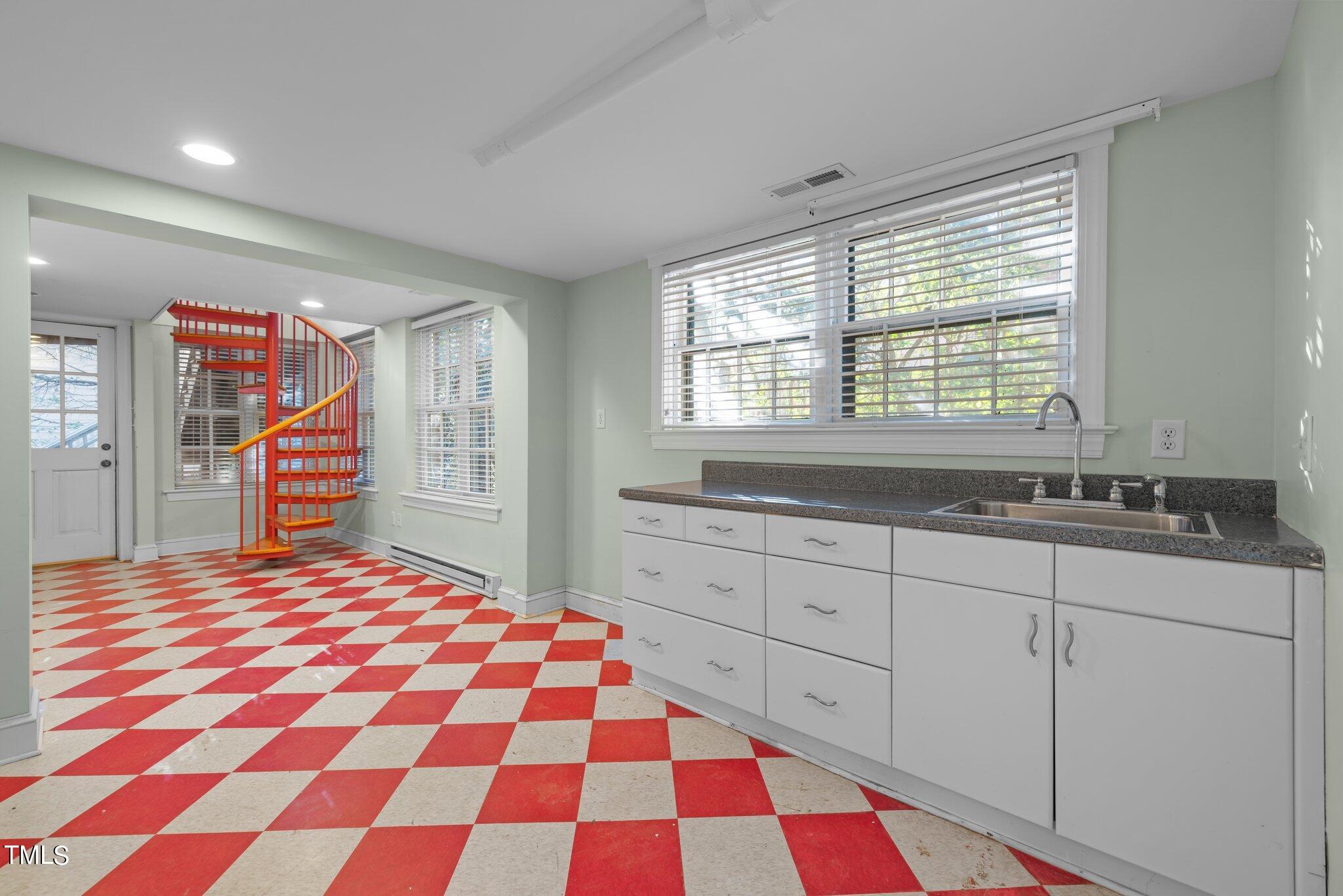 228 Furches Street Raleigh, NC 27607 - Photo 41 of 65 a bedroom with a bed and a sink