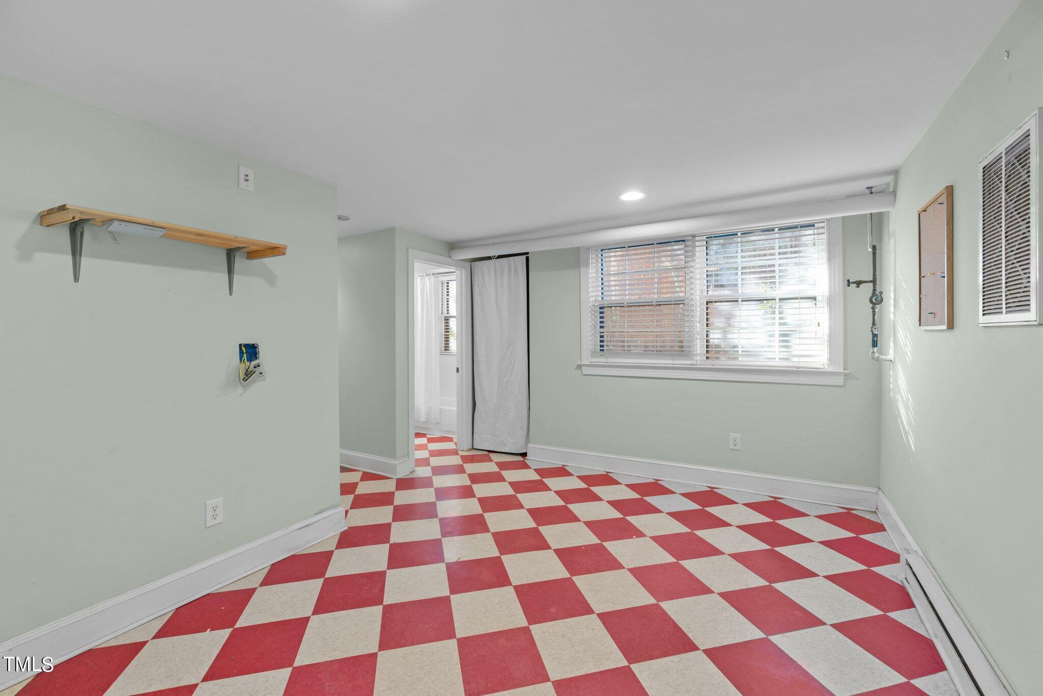 228 Furches Street Raleigh, NC 27607 - Photo 43 of 65 a bedroom with a black and white checkered floor