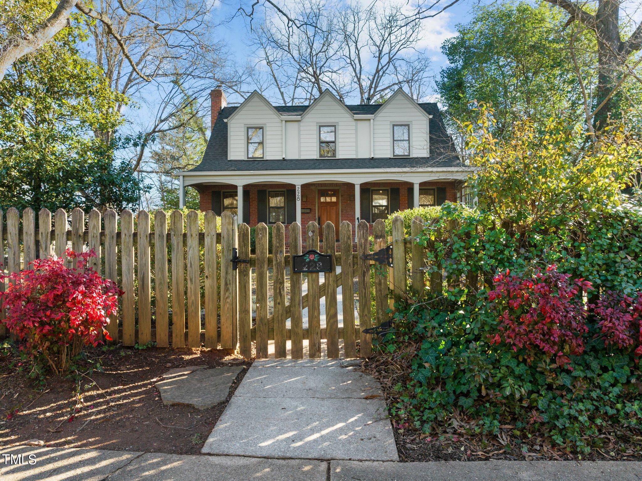 228 Furches Street Raleigh, NC 27607 - Photo 56 of 65 a front view of a house with a garden