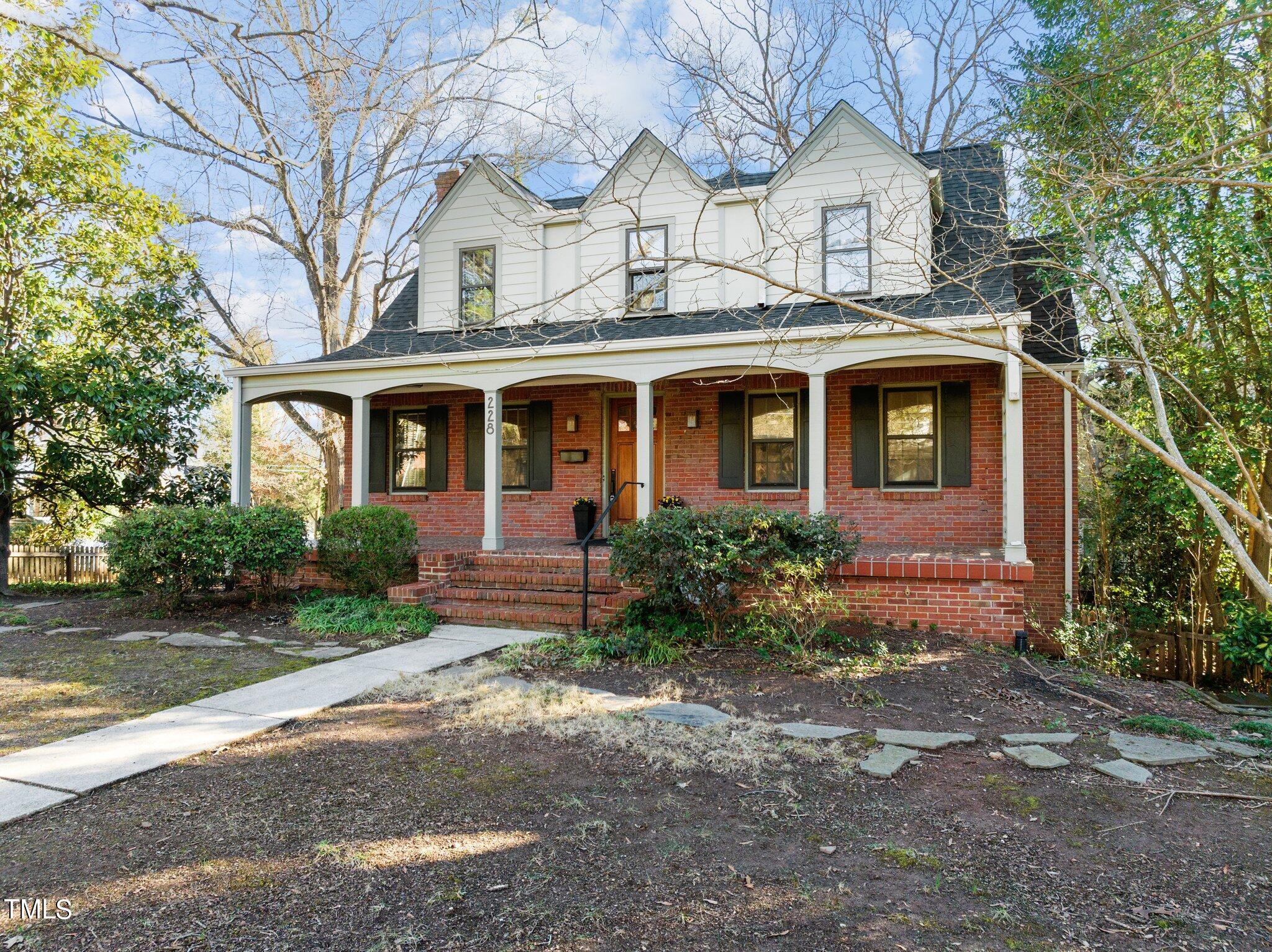 228 Furches Street Raleigh, NC 27607 - Photo 57 of 65 a view of a white house with large windows and a tree