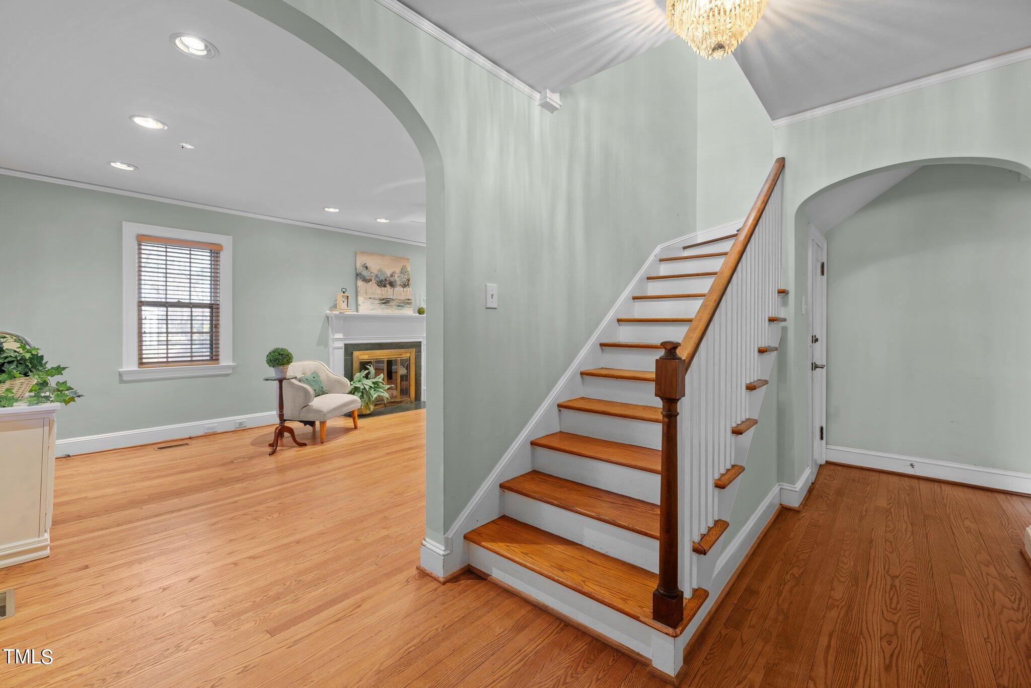 228 Furches Street Raleigh, NC 27607 - Photo 7 of 65 a view of entryway with wooden floor and stairs