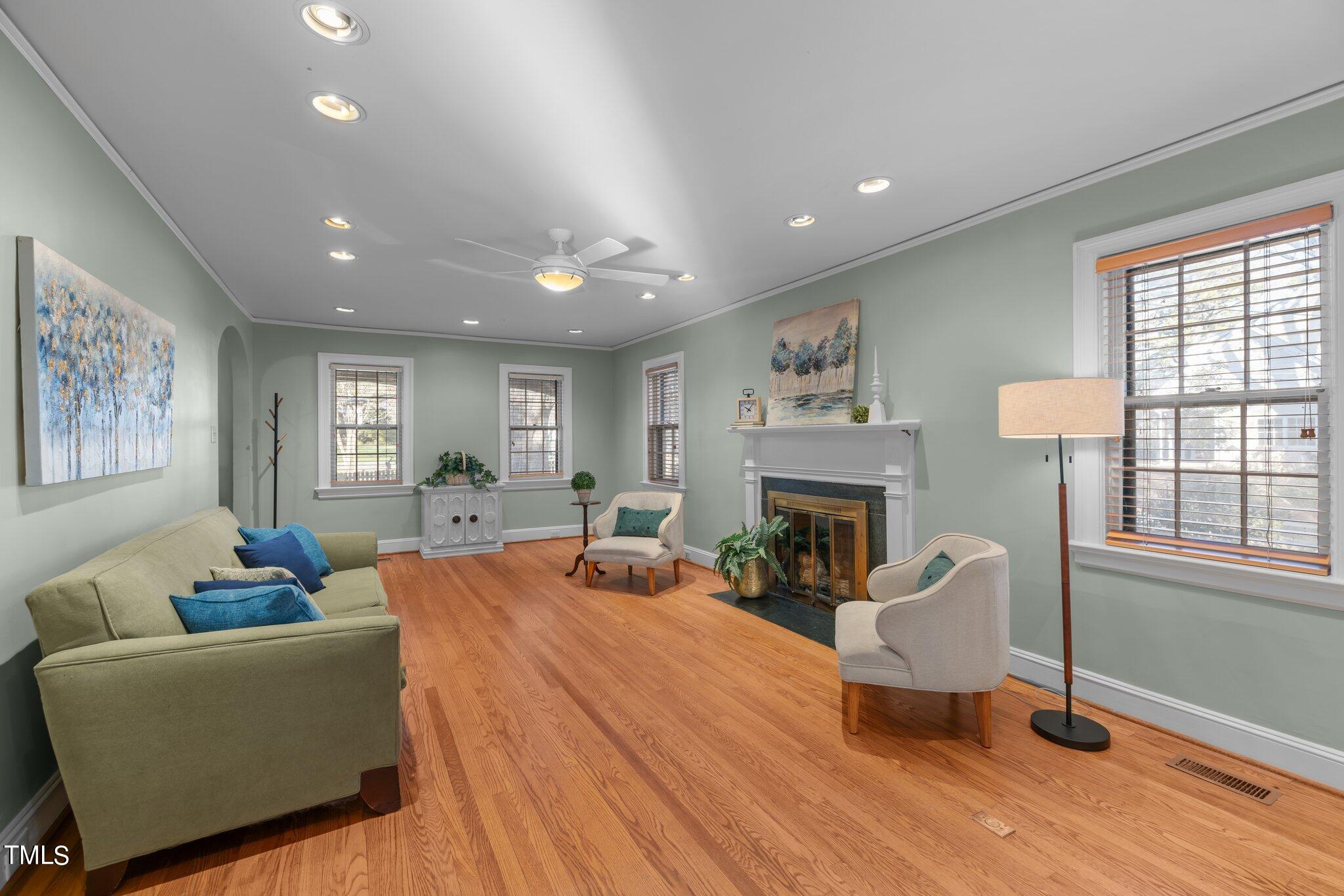 228 Furches Street Raleigh, NC 27607 - Photo 10 of 65 a living room with furniture a fireplace and a window