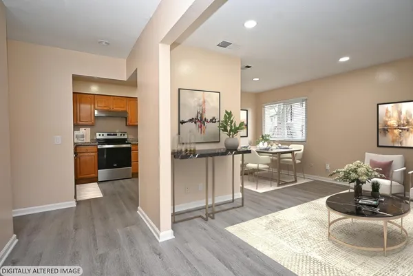 a living room with furniture and a kitchen