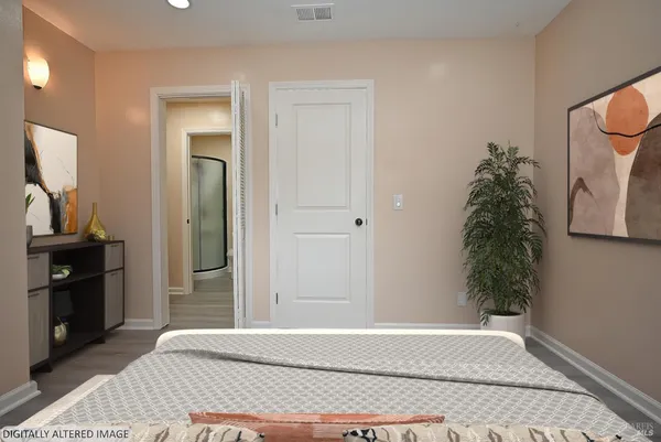 a bedroom with a bed and a mirror