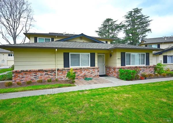a front view of house with yard and green space