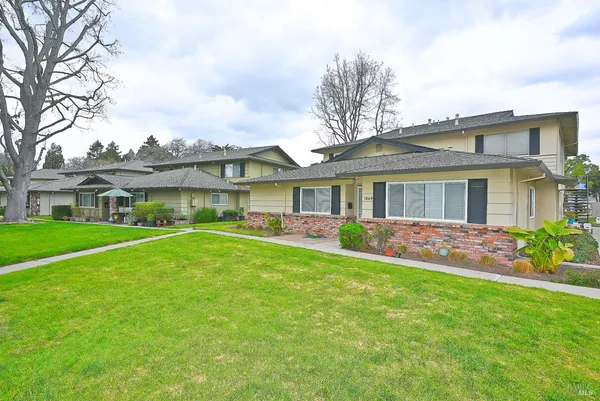 a front view of house with yard and green space