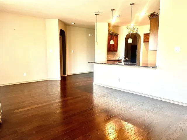 a view of a room with wooden floor