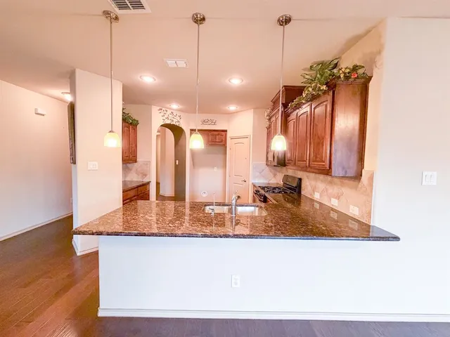 a view of a room with wooden floor