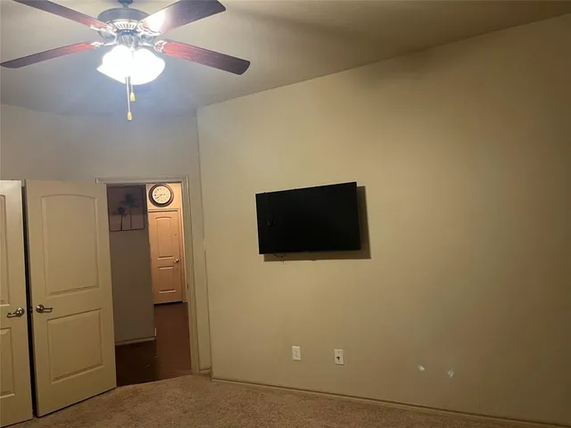 a view of a livingroom with a flat screen tv and a fan