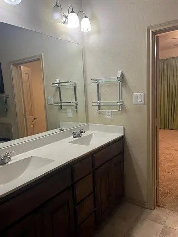 a bathroom with a double vanity sink and a mirror