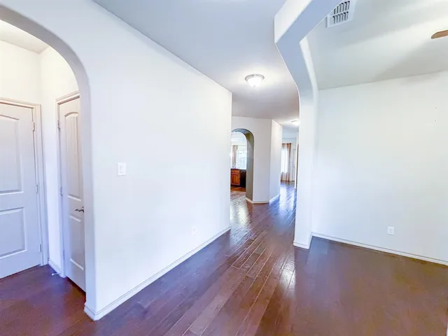 a view of a hallway with wooden floor