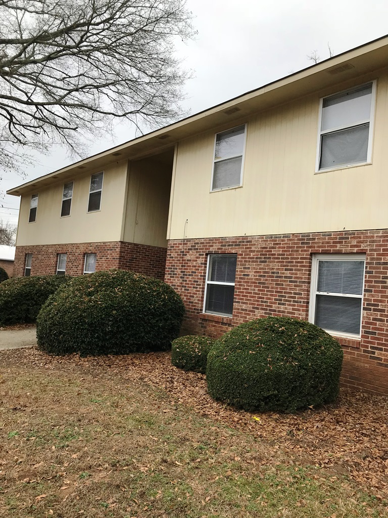 This structure features a harmonious blend of brick and siding, offering a timeless aesthetic.