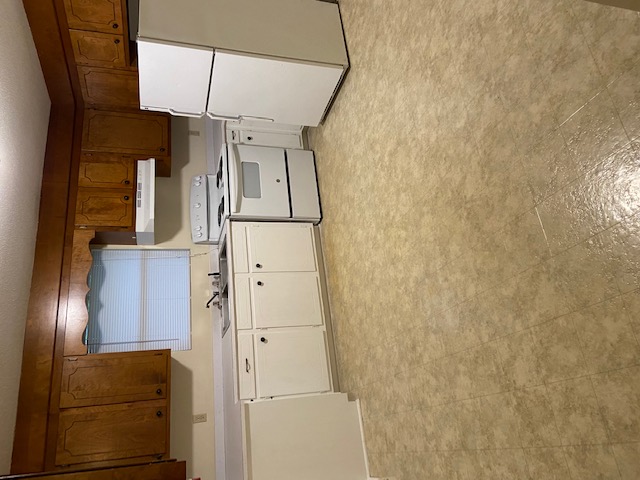 205 Kirk Lane, Unit 6 Pendleton, SC 29670 - Photo 6 of 7 This kitchen features classic cabinetry, white appliances, and durable flooring.