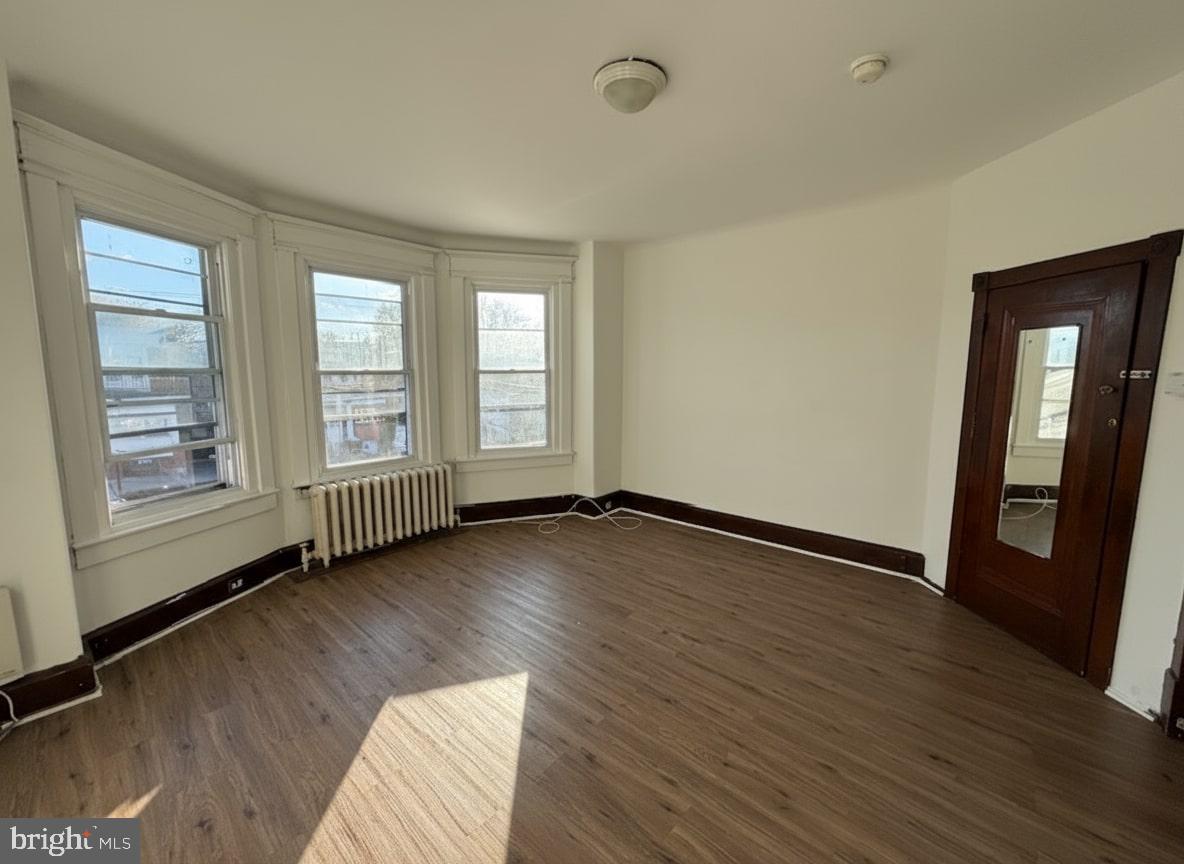 605 West Olney Avenue, Unit 2 Philadelphia, PA 19120 - Photo 2 of 11 an empty room with wooden floor and windows