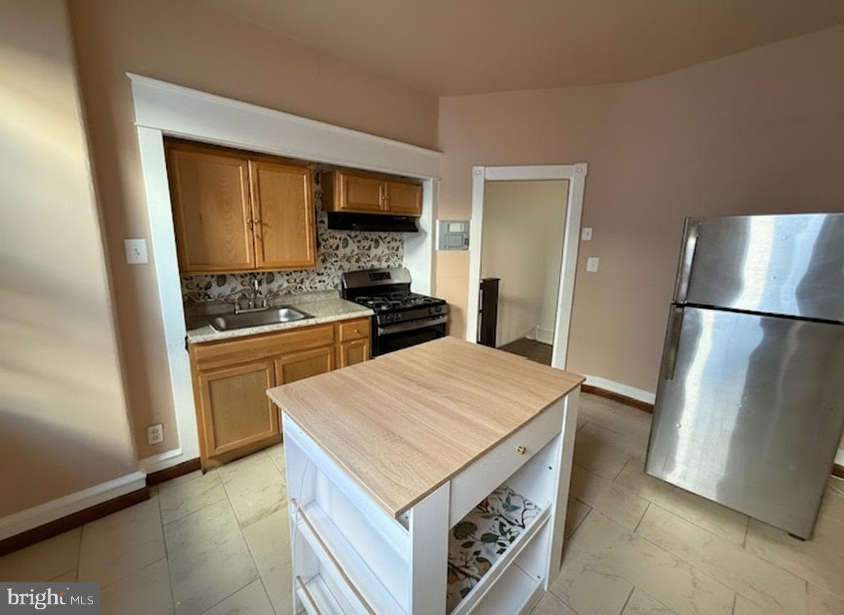 605 West Olney Avenue, Unit 2 Philadelphia, PA 19120 - Photo 5 of 11 a kitchen with a appliances and a refrigerator