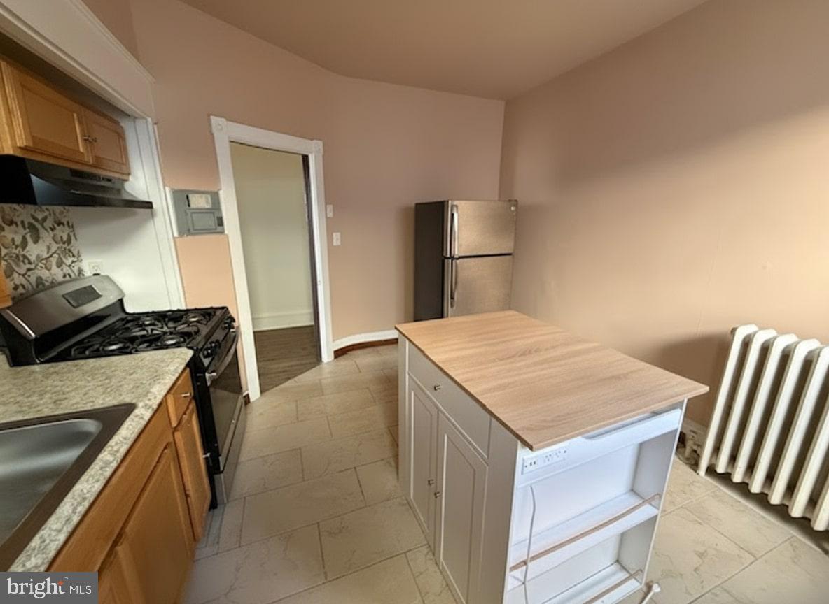 605 West Olney Avenue, Unit 2 Philadelphia, PA 19120 - Photo 6 of 11 a kitchen that has a cabinets and a stove