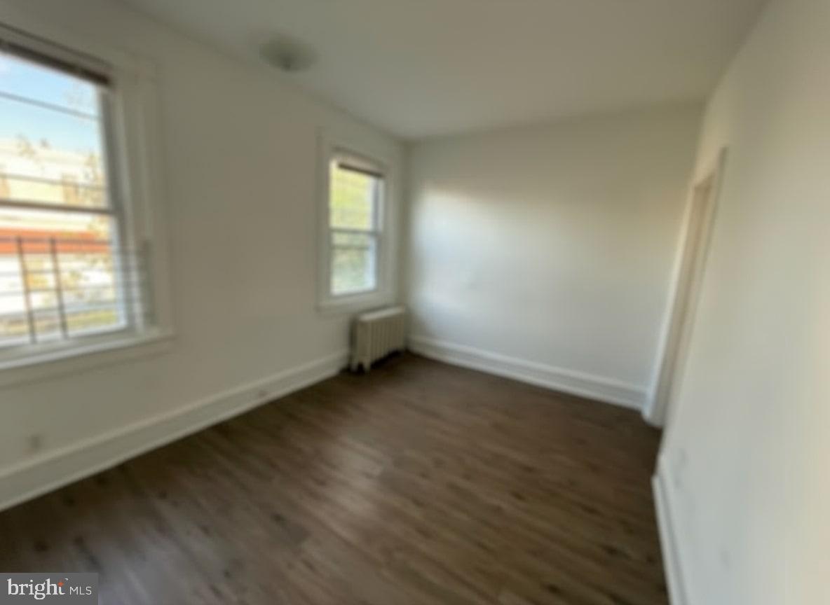 605 West Olney Avenue, Unit 2 Philadelphia, PA 19120 - Photo 7 of 11 an empty room with wooden floor and windows