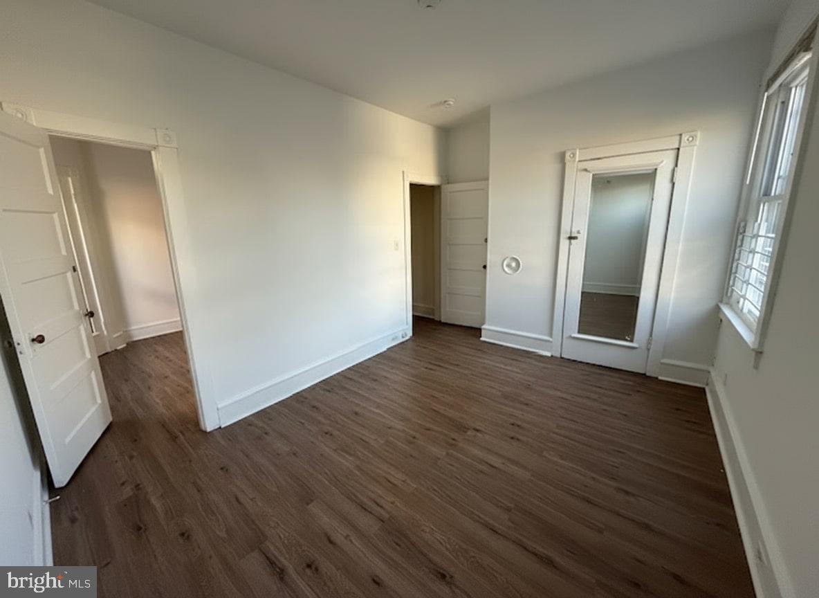605 West Olney Avenue, Unit 2 Philadelphia, PA 19120 - Photo 8 of 11 an empty room with wooden floor and mirror
