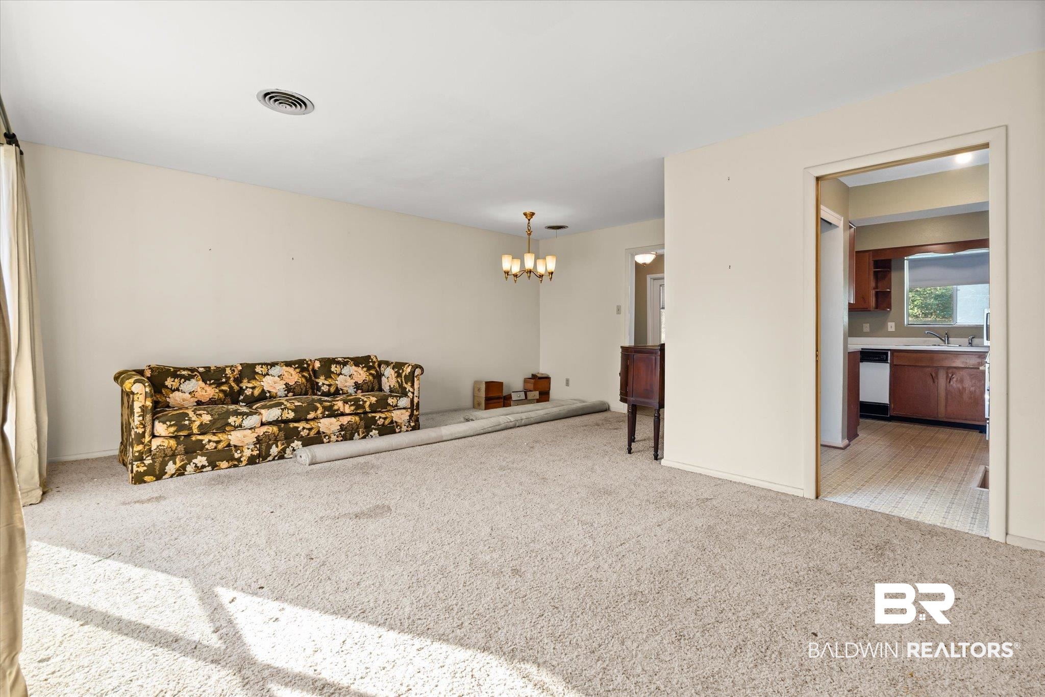 602 Markham Drive Mobile, AL 36609 - Photo 3 of 20 Living room featuring a notable chandelier, sink, and carpet
