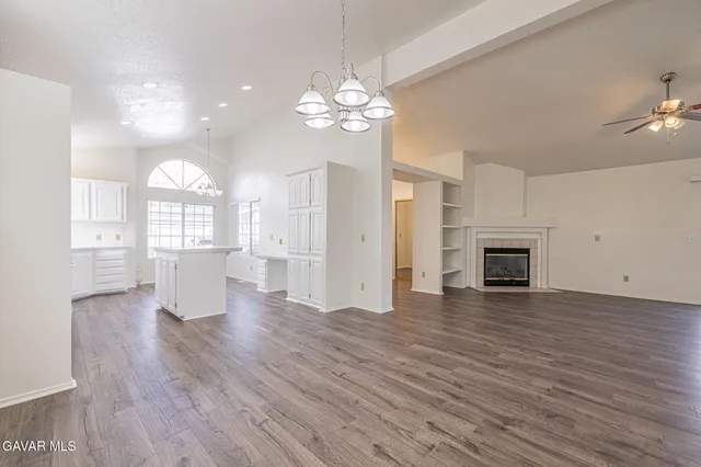 a view of a room with wooden floor and a fireplace