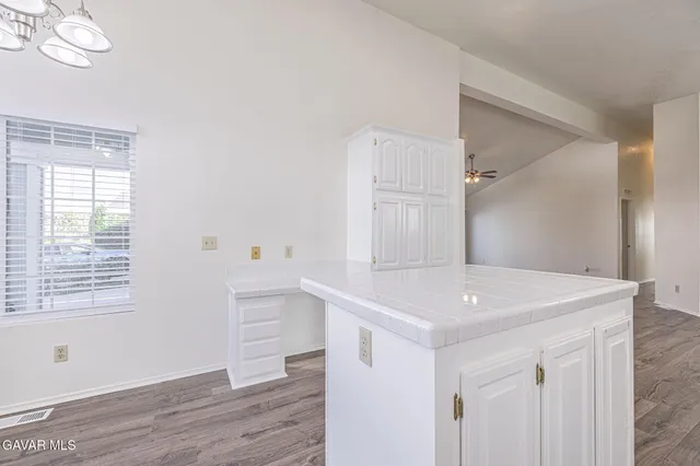 a view of a kitchen with wooden cabinet and floors