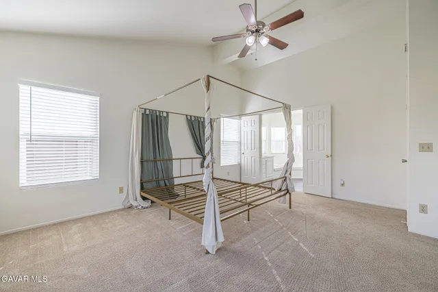 a view of workspace with wooden floor and ceiling fan