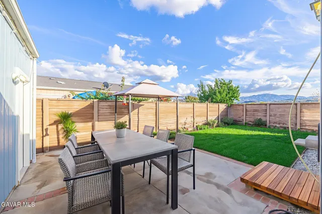 a view of a patio with a yard