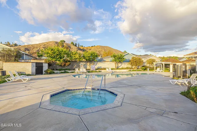 a view of a garden with a small yard and wooden fence