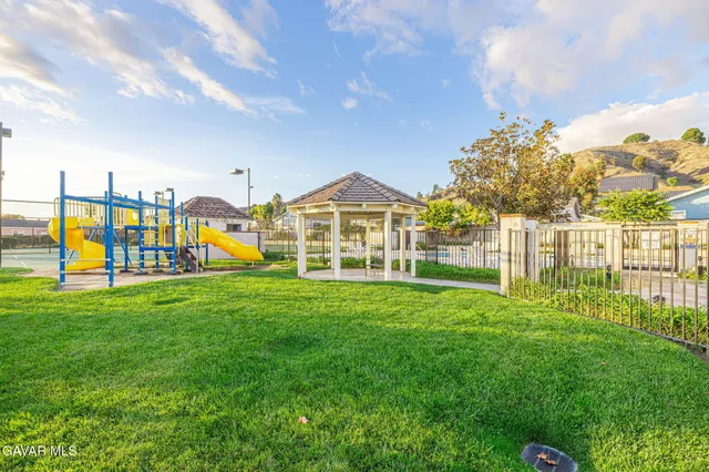a view of a house with a big yard and large trees