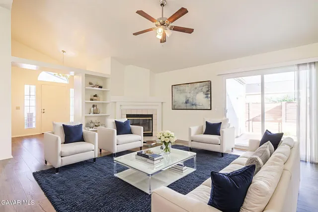 a living room with furniture a table and a large window
