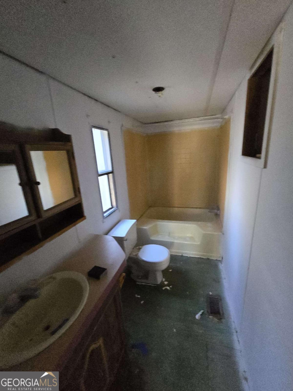 211 Waycross Road Savannah, GA 31419 - Photo 7 of 8 a bathroom with a sink toilet and mirror